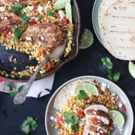 Mexican chicken and corn in a pan next to a serving on a plate.
