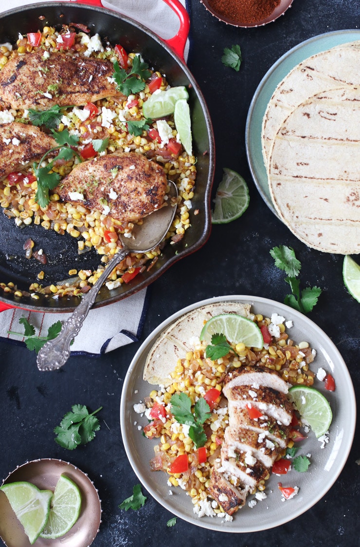 Mexican chicken and corn in a pan next to a serving on a plate.