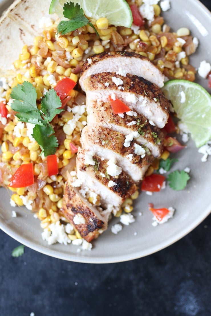 Mexican chicken and corn served on a plate.