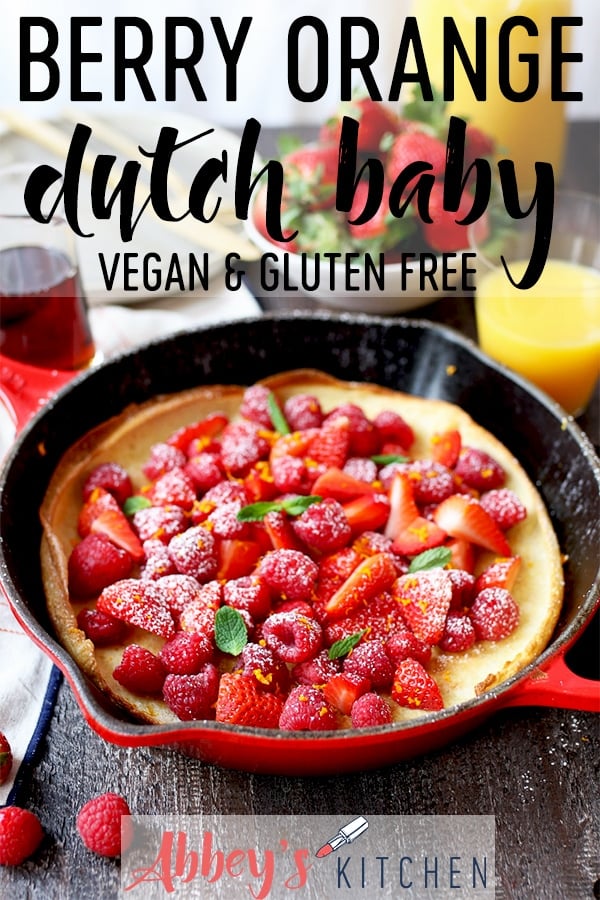pinterest image of Vegan dutch baby in a pan topped with berries and orange zest with text overlay