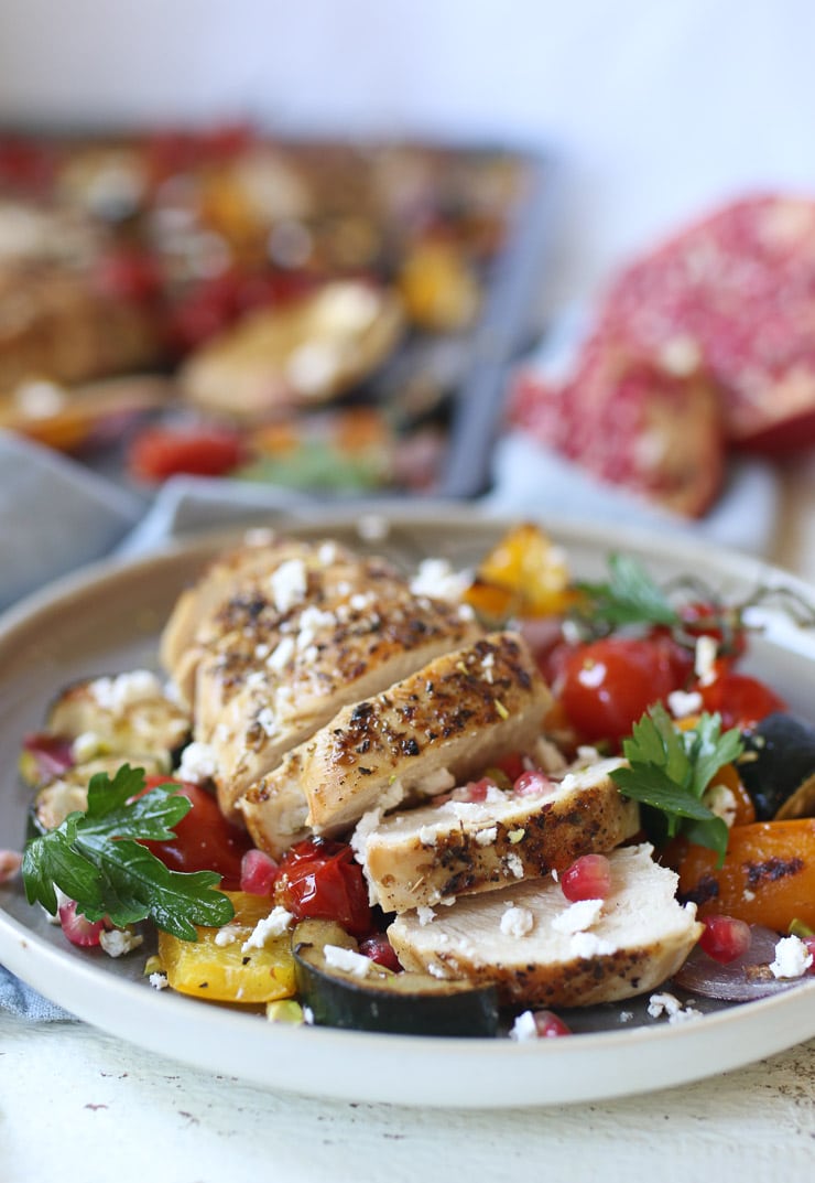 Plate of veggies with chicken breast to meet protein intake recommendations.