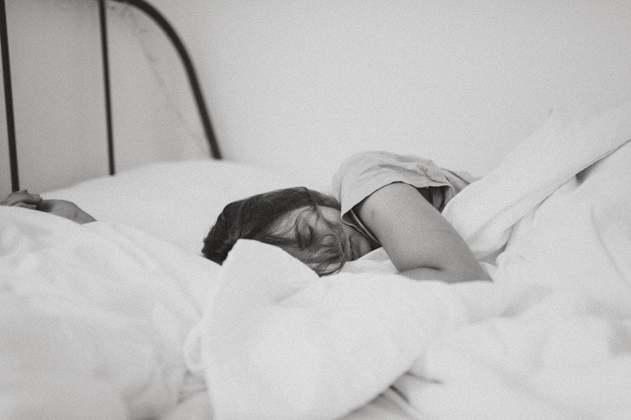 Women sleeping in a bed to discuss things to avoid while breastfeeding.