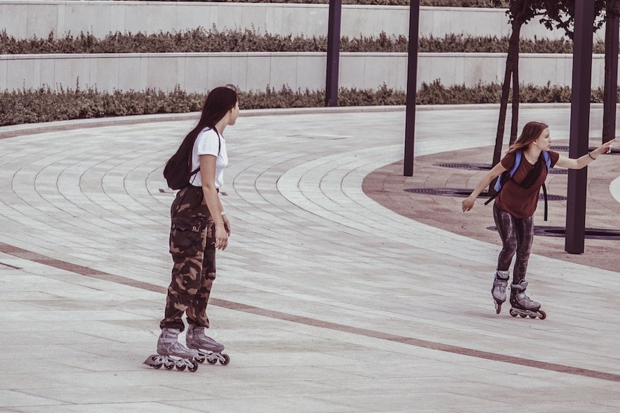 Two women rollerblading.