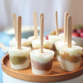 Baby popsicles on a wooden plate.