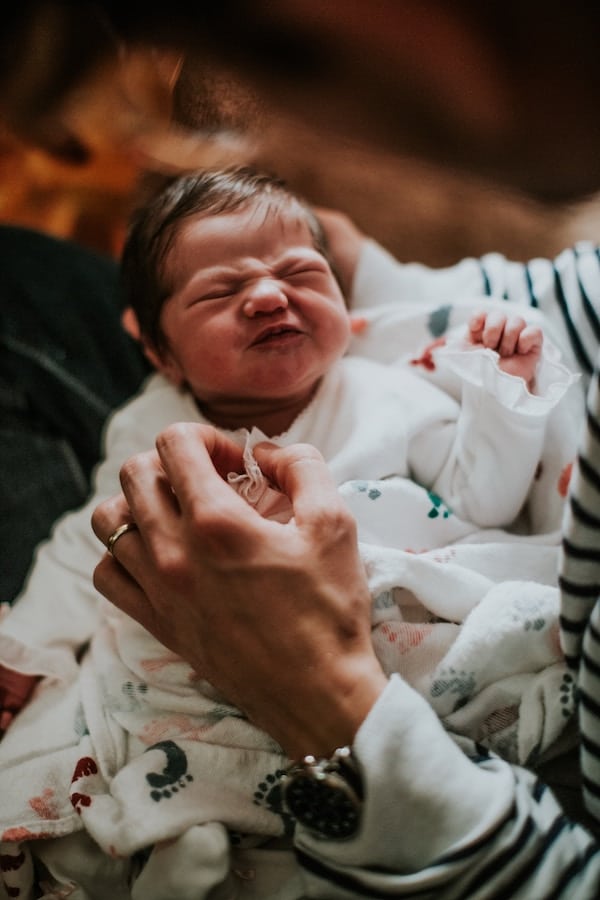 Person holding their baby.