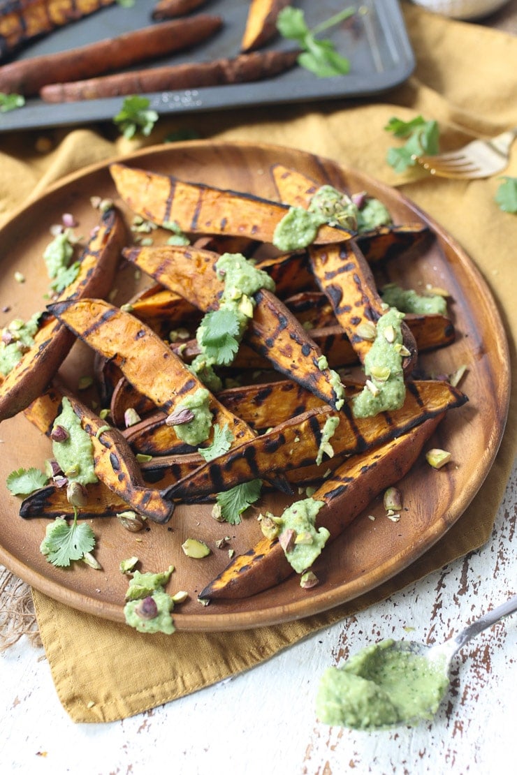 Plate with grilled sweet potatoes recipe with avocado lime sauce.