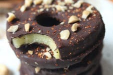 Chocolate covered pineapple slices on a teal plate.