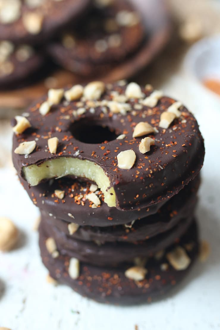 Chocolate covered pineapple slices on a teal plate.