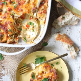 Overhead image of a serving of cauliflower casserole cut out of a baking dish and placed on a plate.