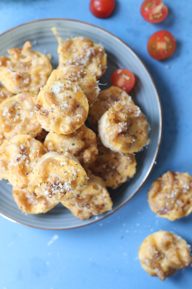 Homemade mac and cheese bites on a blue plate.