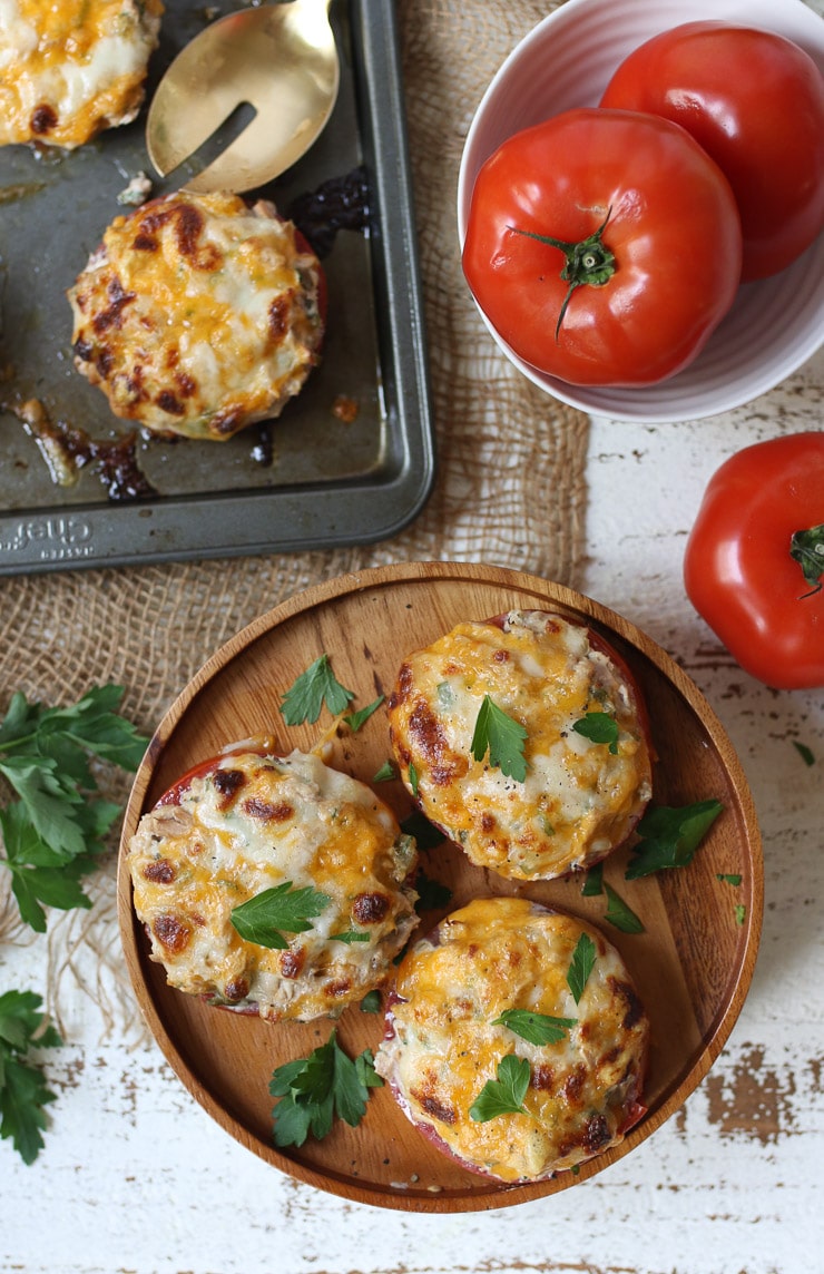 Birds eye view of 3 tuna melts served on a wooden plate.