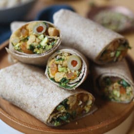 Moroccan wraps served on a wooden plate.