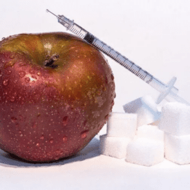 Apple with a needle and sugar to discuss diet for PCOS.