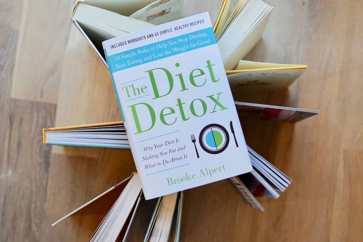 Birds eye view of a diet detox book on a wooden surface