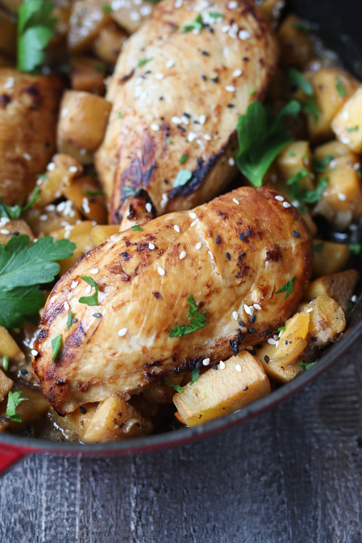 Close up of persimmon and ginger chicken in a red pot.