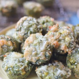 Close up of mini spinach muffins on a yellow plate.