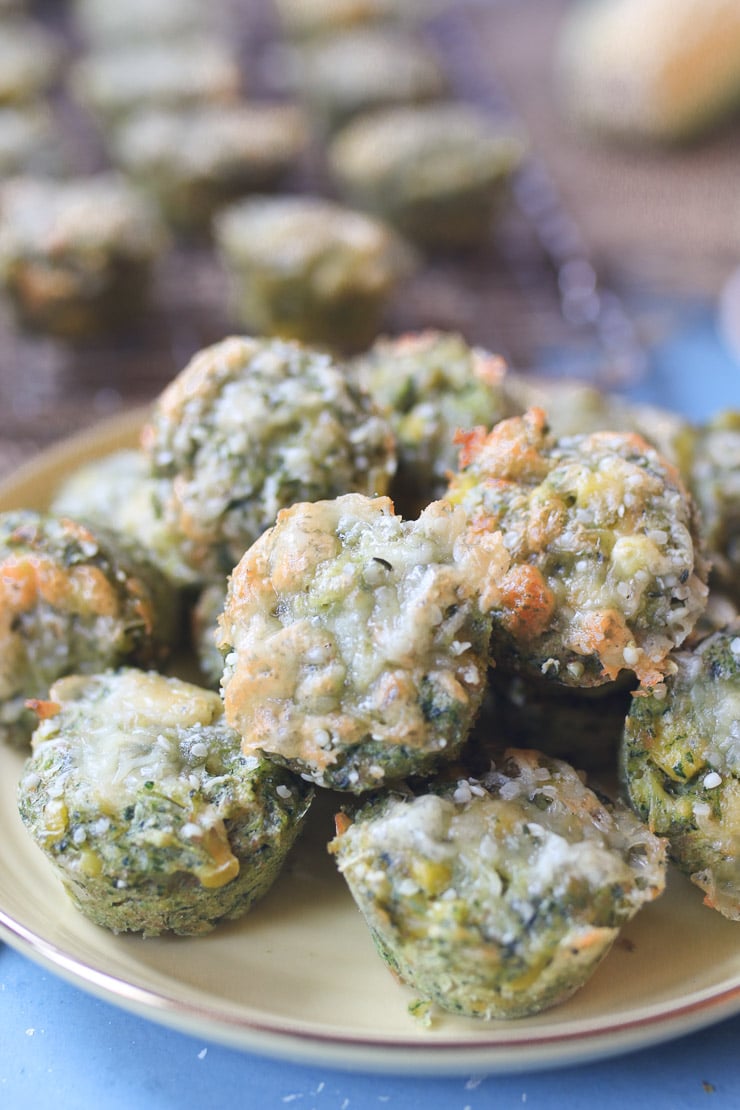 Close up of mini spinach muffins on a yellow plate.