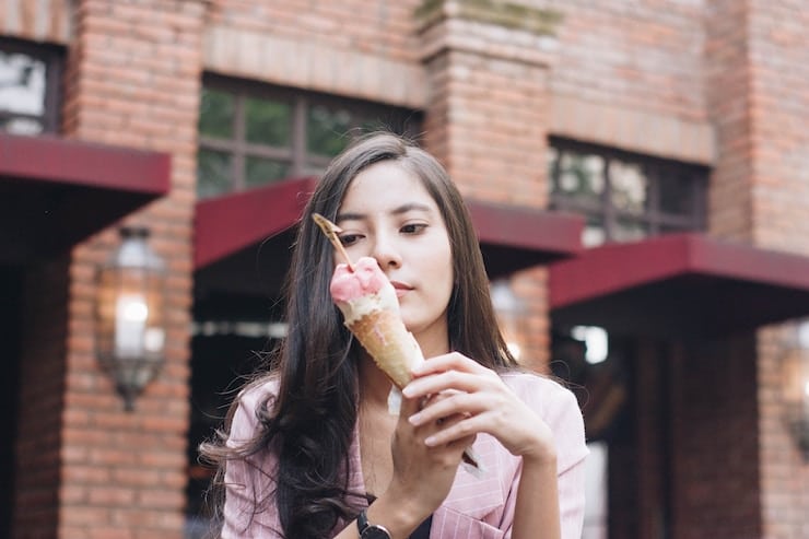 Girl with food obsession staring at a cone of ice cream.