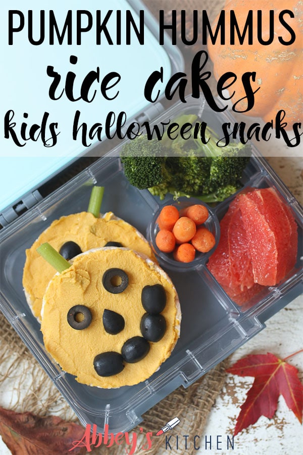Pinterest image of rice cakes topped with hummus in a lunchbox with text overlay.