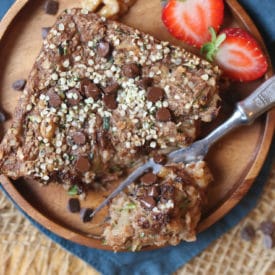 Baked oatmeal square on a wooden plate.