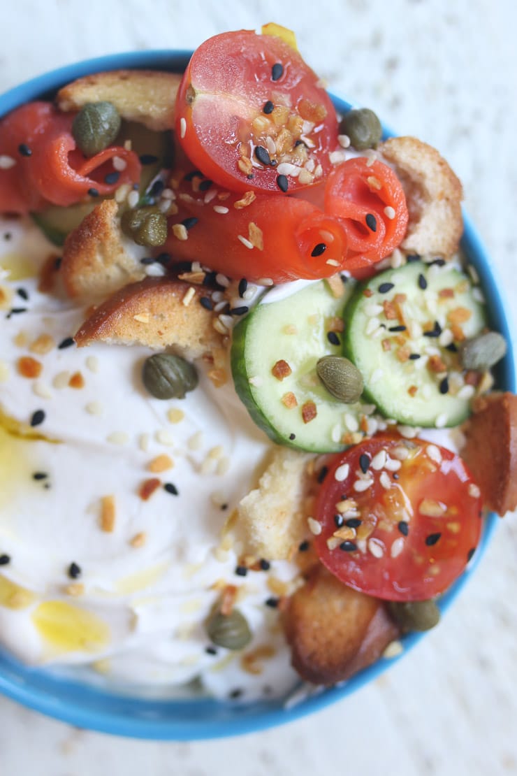 Yogurt bowl topped with smoked salmon and bagel chips. 