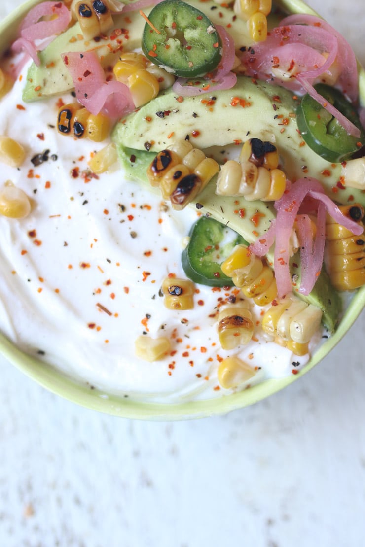 greek Yogurt topped with with avocado and corn. 