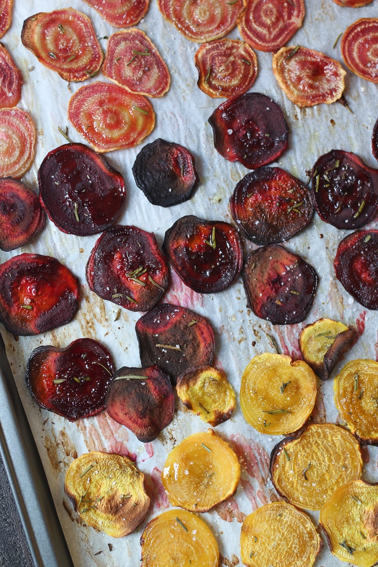 Birds eye view of roasted beet slices on a sheet pan. 