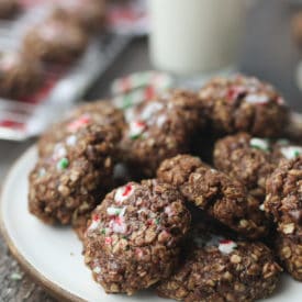 Chocolate candy cane cookies served on a white plate.