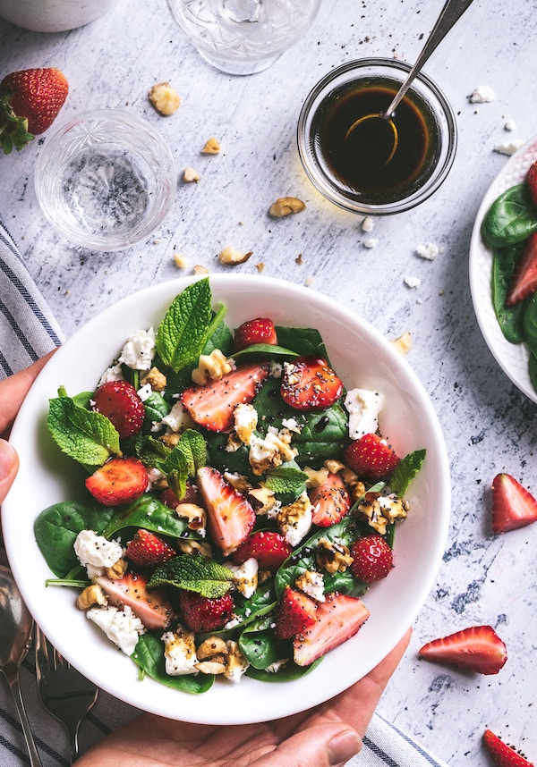 Salad served in a white bowl.