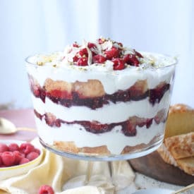 Berry trifle served in a large glass dish.