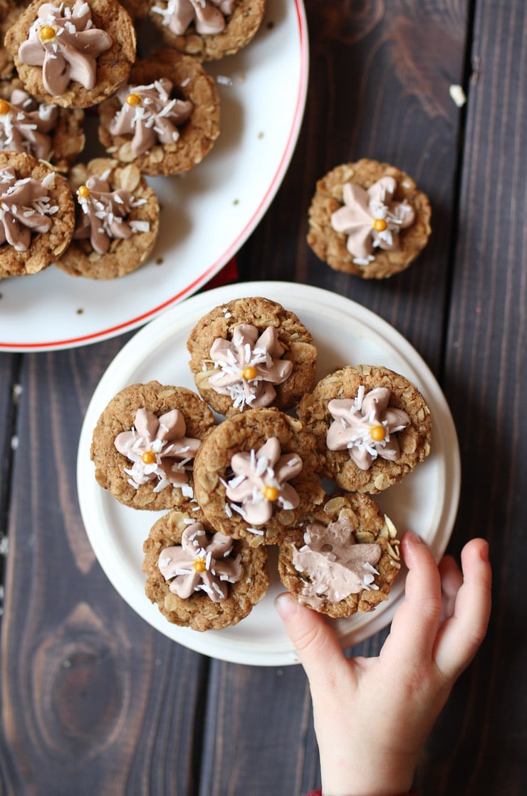 Toddler's hand reaching for oatmeal cookie cups.