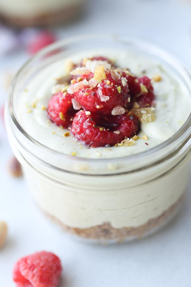 Close up of no bake cheesecake recipe parfait in a glass mason jar.