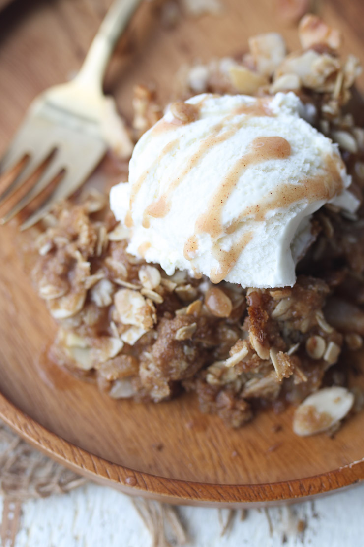 Pear crisp with scoop of ice cream on top. 