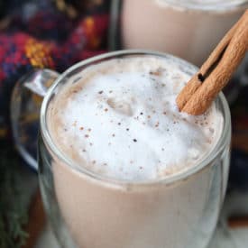 Egg nog drink in a clear mug.