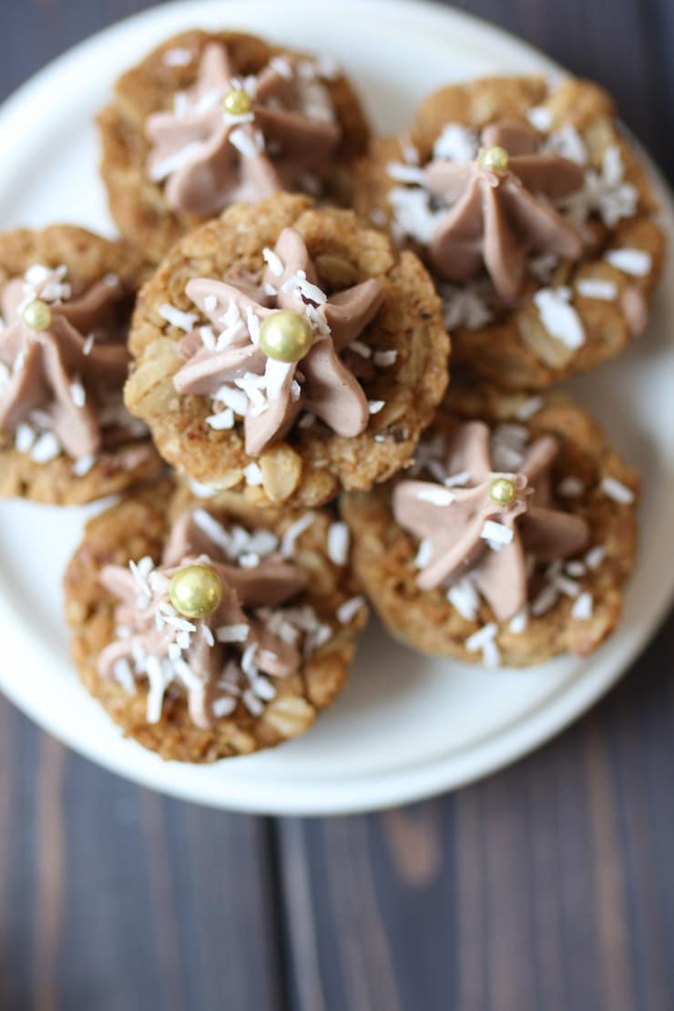 Birds eye view of pile of oatmeal chocolate cookies on a white plate.