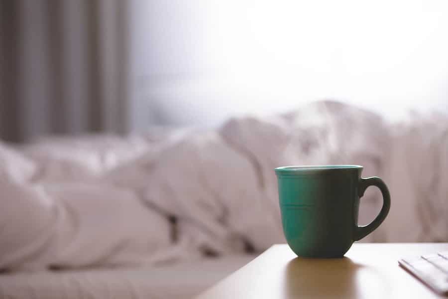 Mug of detox tea on table for bloating