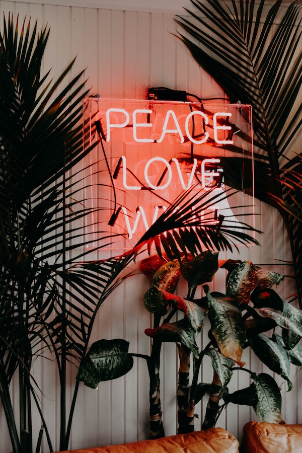 Neon sign about making peace with intuitive eating. 