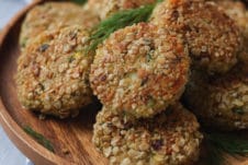 Fish cakes served on a wooden plate.