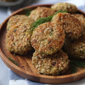 Fish cakes served on a wooden plate.