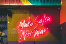 Neon sign about making peace with food.