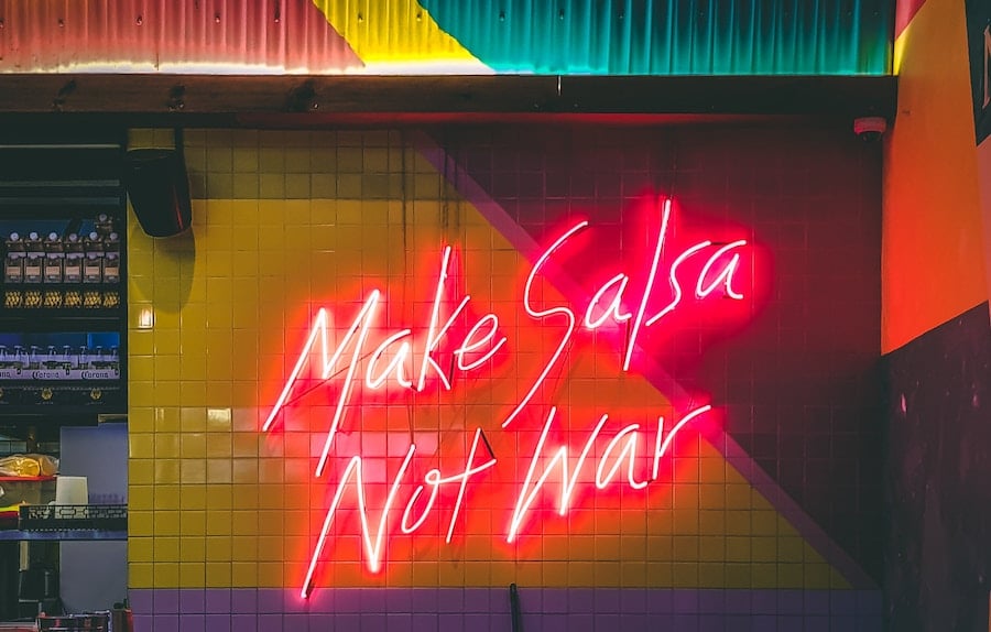 Neon sign about making peace with food in intuitive eating. 