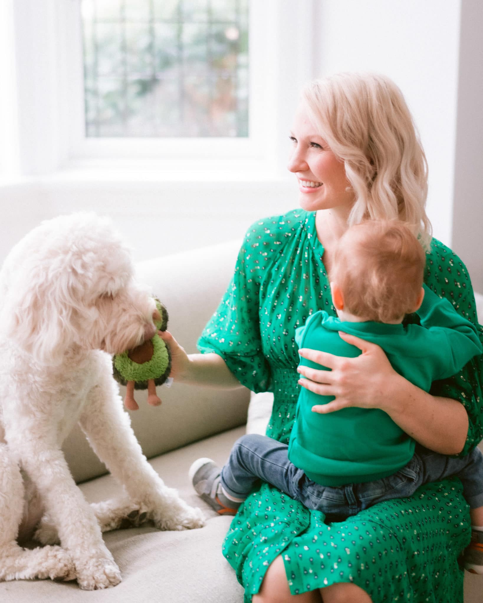 Abbey in a green dress with baby E and poppy 