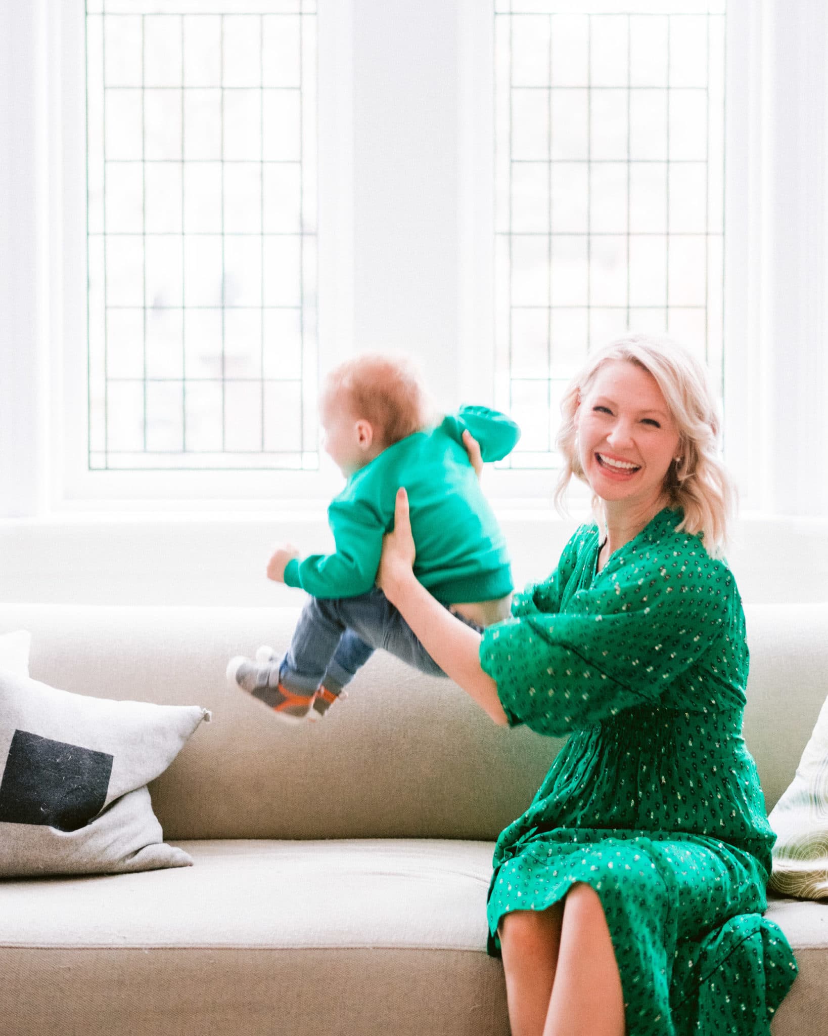 pregnant abbey in green dress lifting baby E
