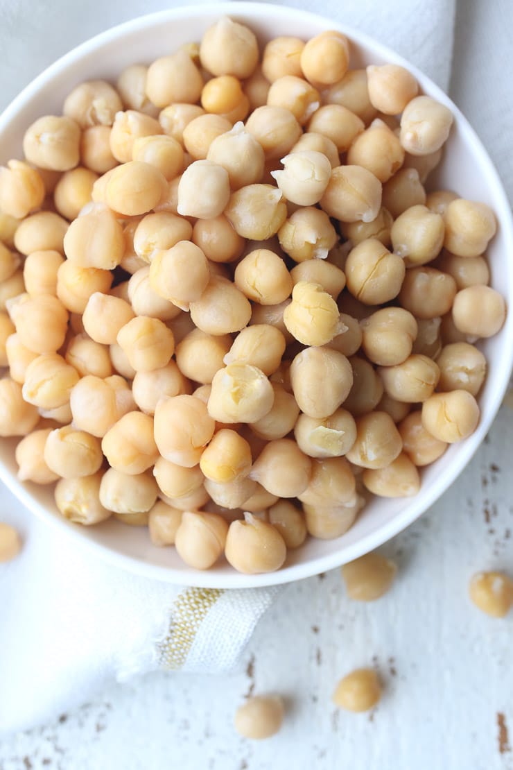 Birds eye view of chickpeas in a white bowl.