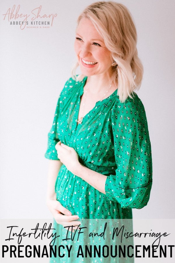 Abbey in a green dress announcing pregnancy 