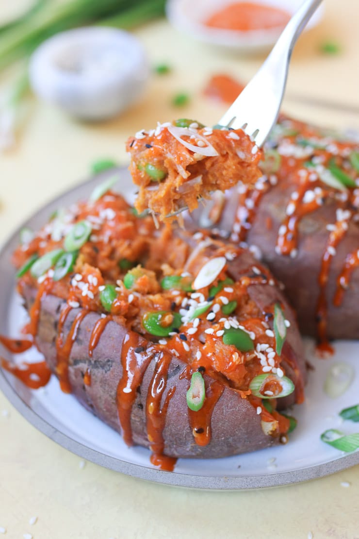 Korean stuffed sweet potato topped with green onion and sesame seed