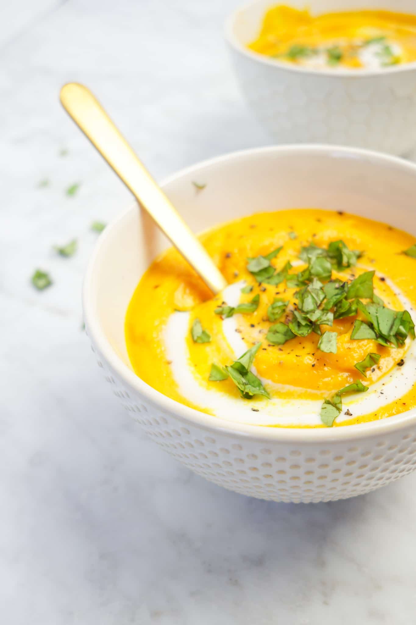 yellow vegan soup recipe topped with cilantro