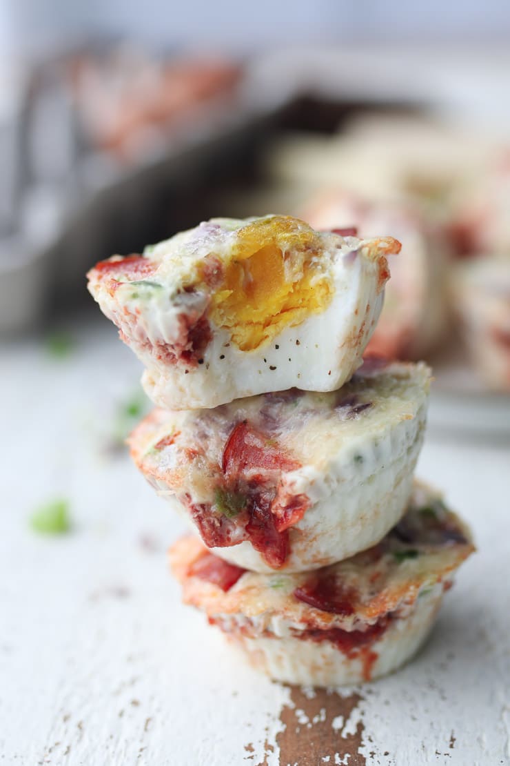 three pizza flavoured egg muffins stacked on top of eachother 