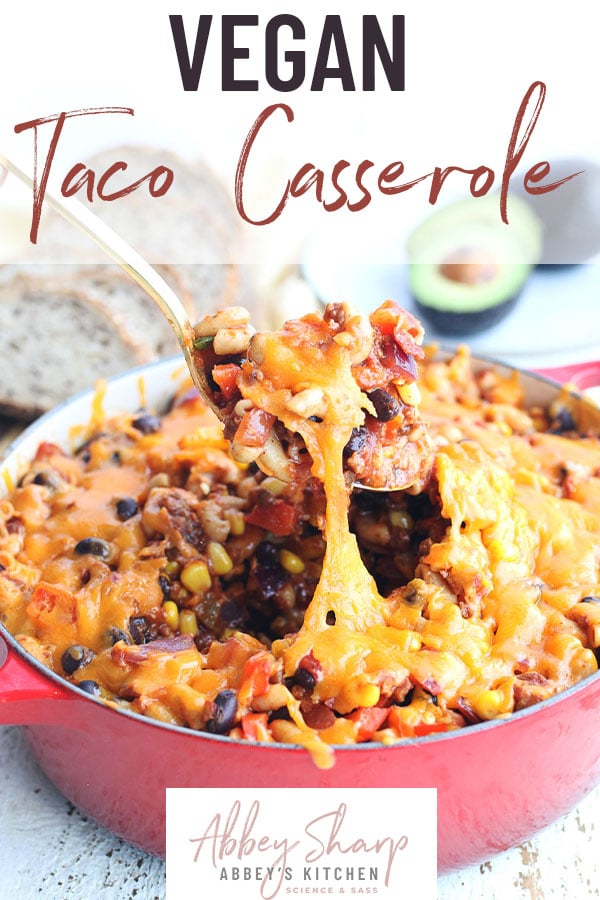 pinterest image of gold spoon scooping up vegan taco casserole in red pot with text overlay