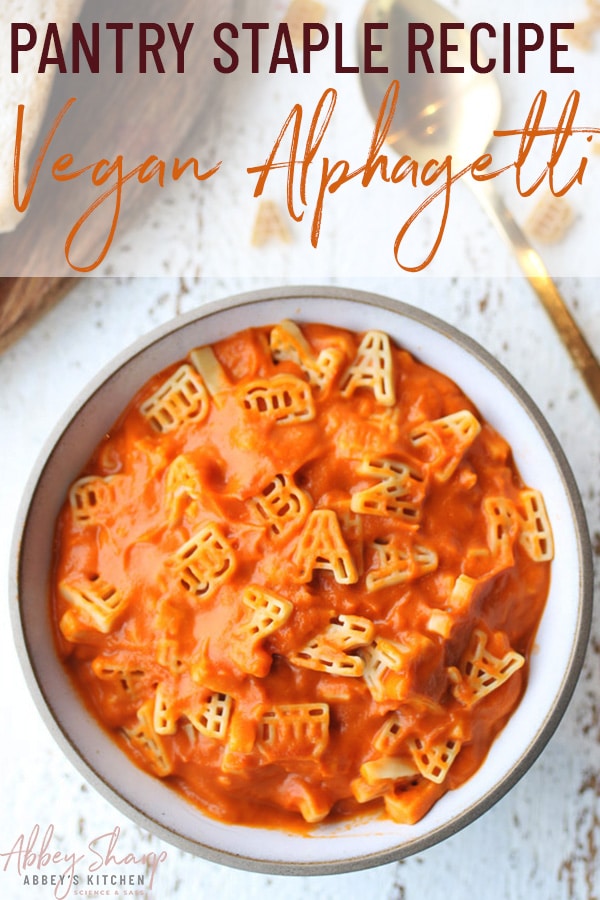 pinterest image of vegan one pot hidden vegetable alphagetti meal in a white bowl next to a gold spoon with text overlay